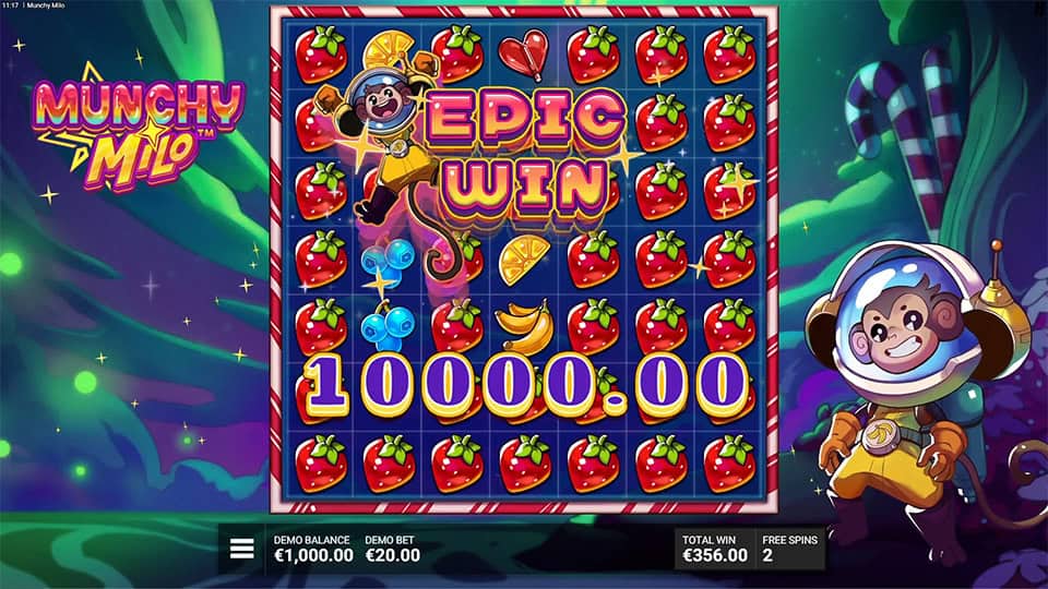 &ldquo;EPIC WIN&rdquo; text flashing across a strawberry-filled grid as Milo celebrates in a glowing candy forest backdrop.